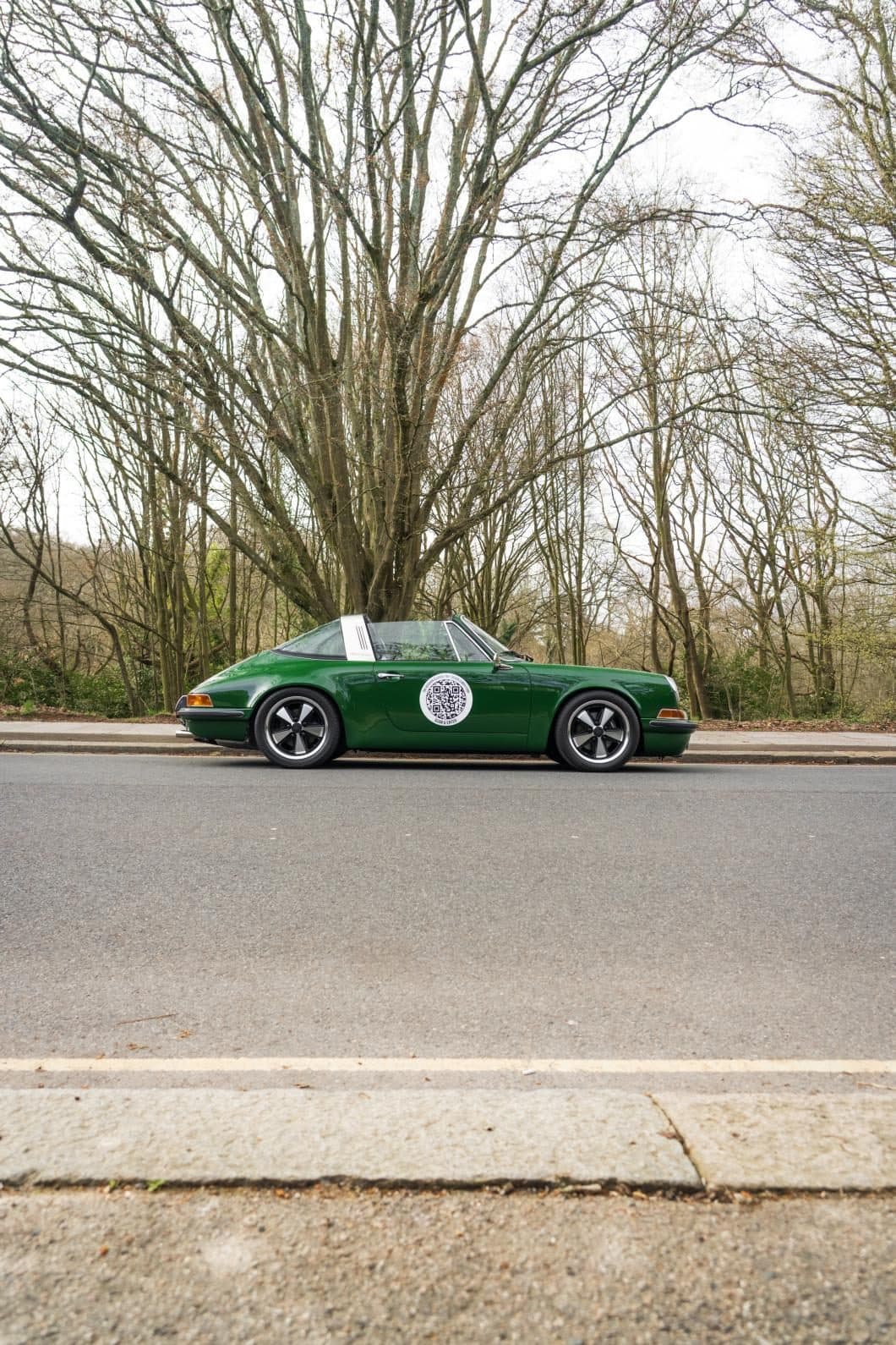 Project 967 on an empty road between bare trees