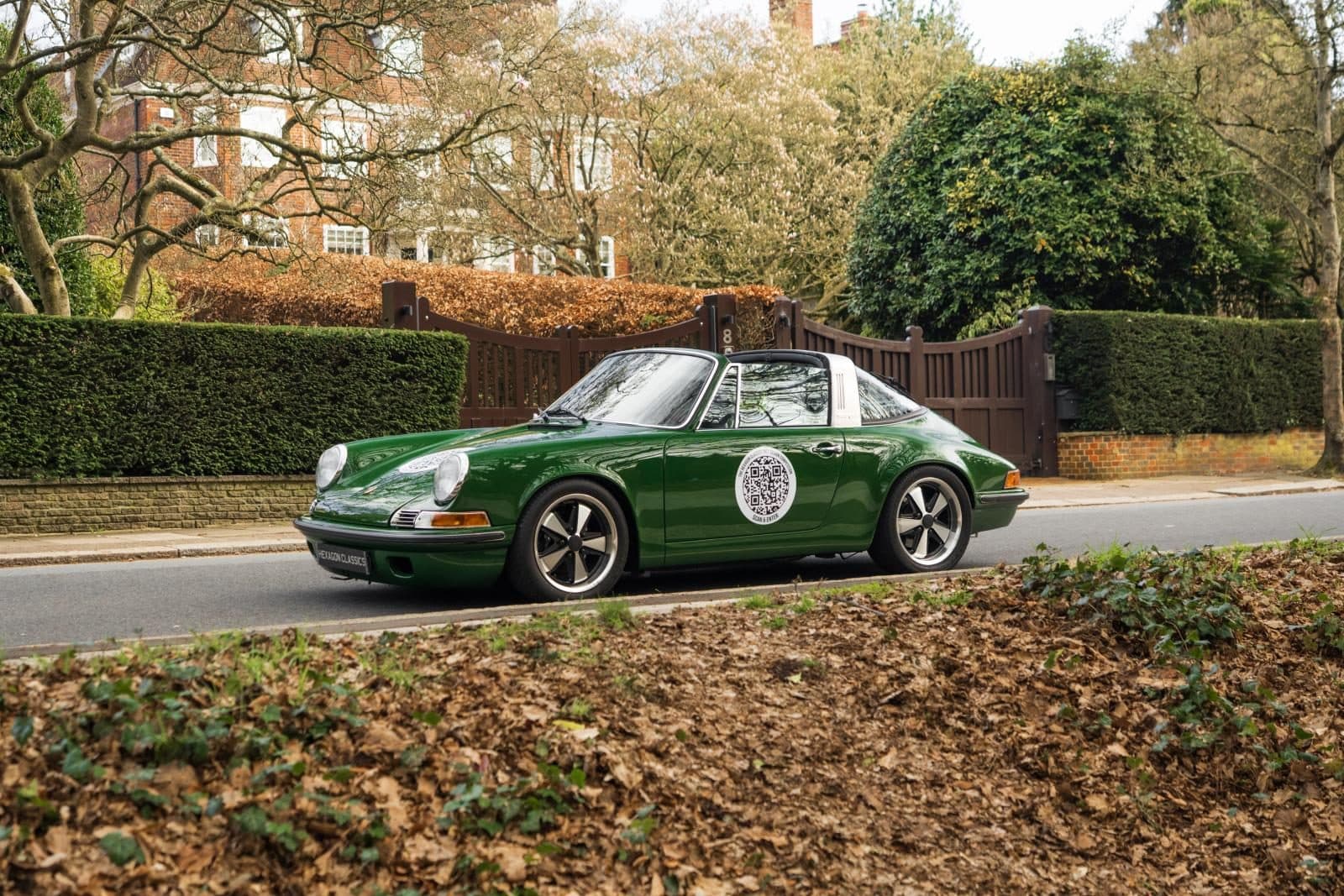Project 967 parked by a hedge with autumn leaves