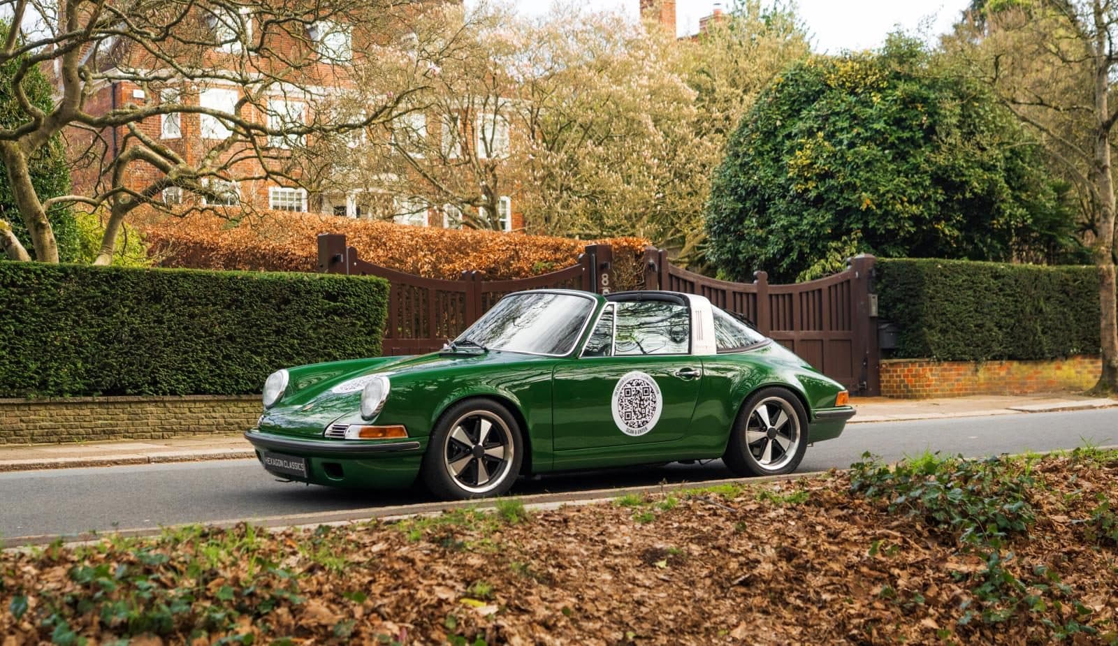 Project 967, a green Porsche 911 Targa, parked on a leafy road