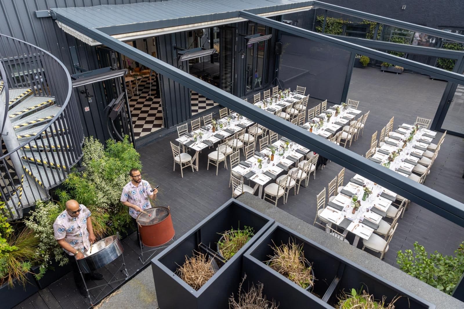 The courtyard laid for a seated party, from above