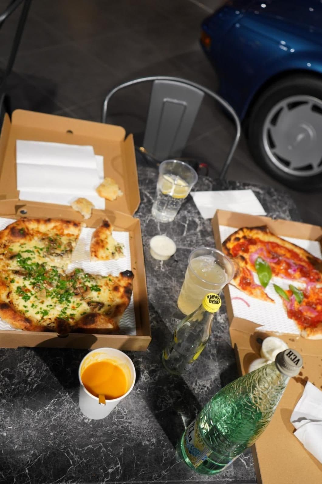 Boxed sourdough pizzas and drinks on a table in the showroom